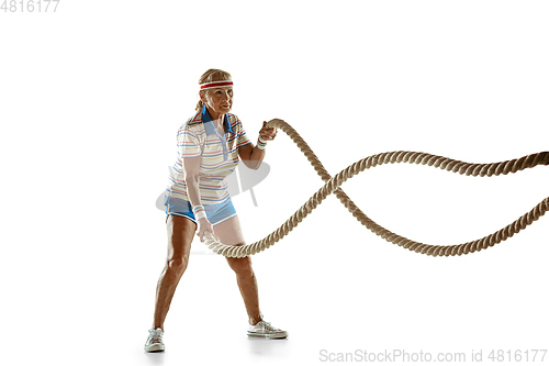 Image of Senior woman training with ropes in sportwear on white background