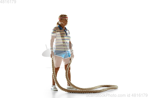 Image of Senior woman training with ropes in sportwear on white background