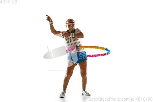 Image of Senior woman training with hoop in sportwear on white background