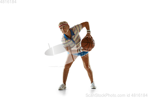 Image of Senior woman playing basketball in sportwear on white background