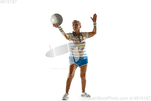 Image of Senior woman playing volleyball in sportwear on white background