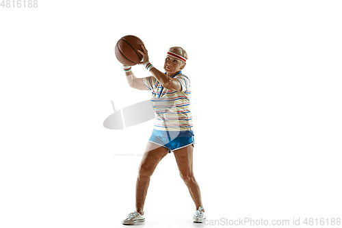 Image of Senior woman playing basketball in sportwear on white background