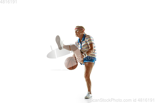 Image of Senior woman playing basketball in sportwear on white background