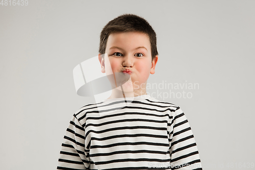 Image of Caucasian boy isolated on white studio background. Copyspace. Childhood, education, emotions concept