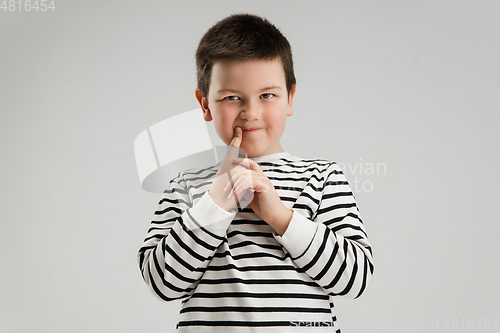 Image of Caucasian boy isolated on white studio background. Copyspace. Childhood, education, emotions concept