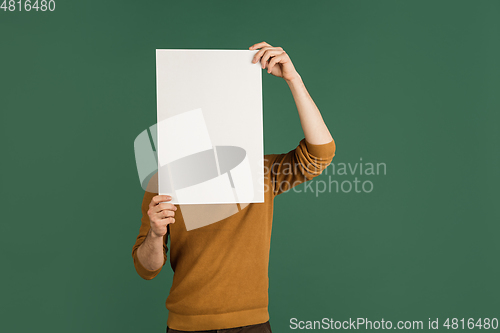 Image of Caucasian man\'s portrait isolated over green studio background with copyspace