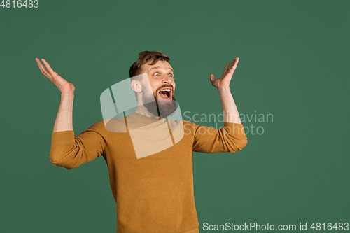 Image of Caucasian man\'s portrait isolated over green studio background with copyspace