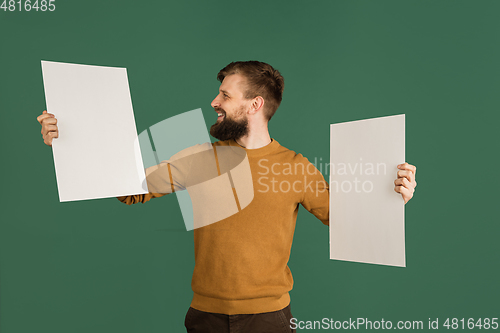 Image of Caucasian man\'s portrait isolated over green studio background with copyspace