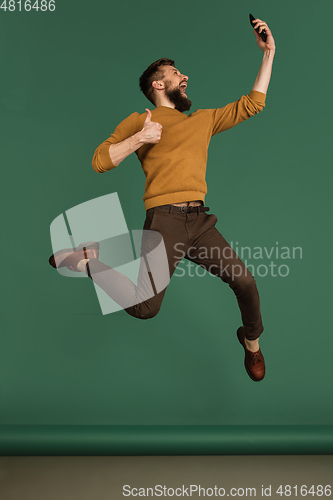 Image of Caucasian man\'s portrait isolated over green studio background with copyspace