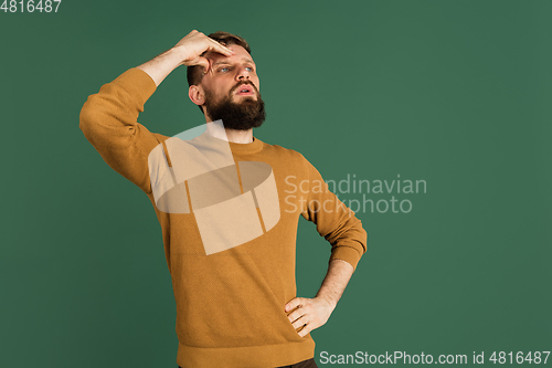 Image of Caucasian man\'s portrait isolated over green studio background with copyspace