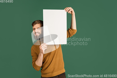 Image of Caucasian man\'s portrait isolated over green studio background with copyspace