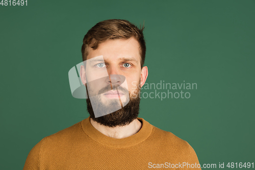 Image of Caucasian man\'s portrait isolated over green studio background with copyspace