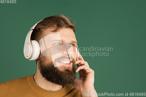 Image of Caucasian man\'s portrait isolated over green studio background with copyspace