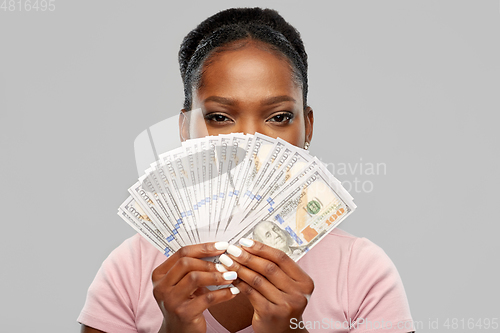 Image of african american woman hiding behind dollar money