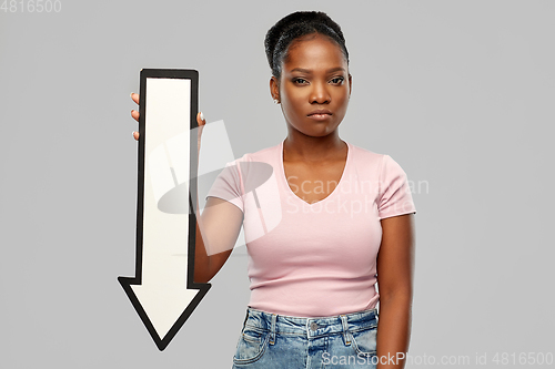 Image of unhappy african woman with downwards arrow