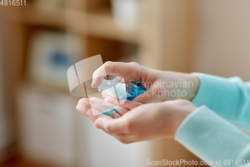 Image of close up of woman spraying hand sanitizer