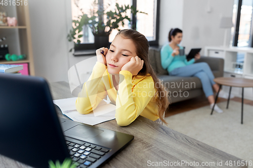 Image of student girl with laptop learning online at home