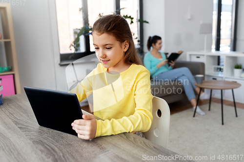 Image of student girl with tablet pc and mother at home