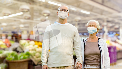 Image of senior couple in medical masks at supermarket