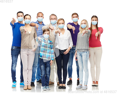 Image of people in medical masks showing thumbs down