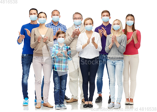 Image of people in medical masks applauding