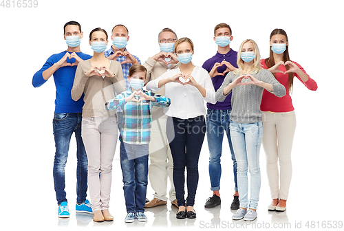 Image of people in medical masks making hand heart gesture