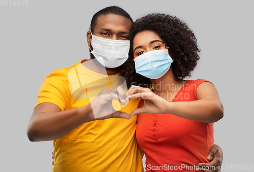 Image of african american couple in medical masks