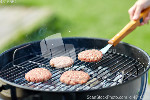 Image of close up of meat cutlets roasting on grill