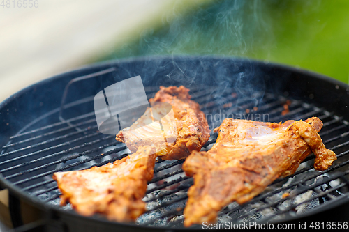 Image of close up of barbecue meat roasting on grill