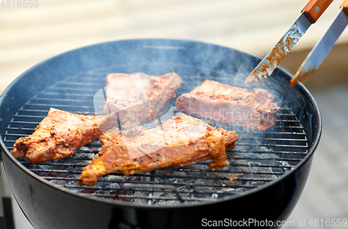 Image of close up of barbecue meat roasting on grill