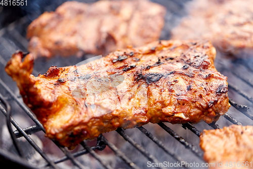 Image of close up of barbecue meat roasting on grill