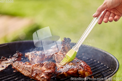 Image of close up of barbecue meat roasting on grill