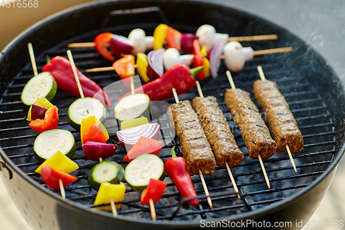 Image of barbecue meat and vegetables roasting on grill