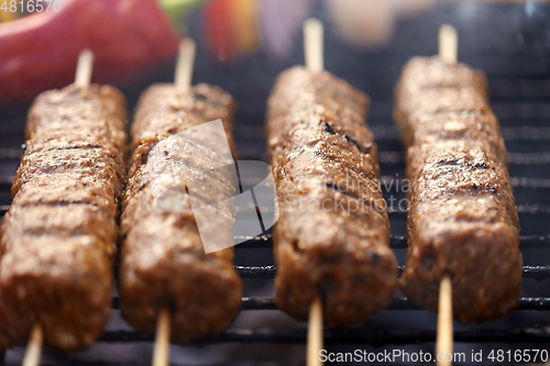 Image of close up of barbecue kebab meat roasting on grill