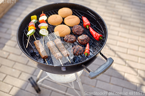 Image of barbecue kebab meat and vegetables on grill