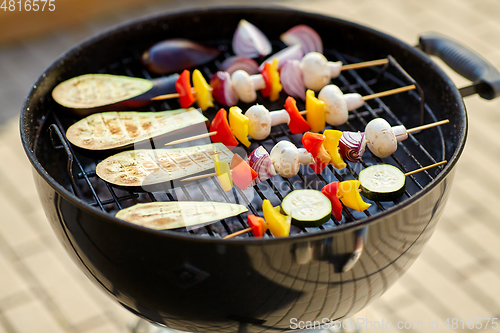 Image of vegetables and mushrooms roasting on brazier grill