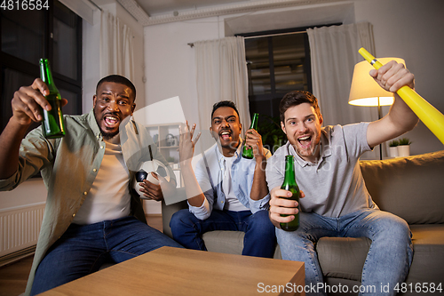 Image of friends or soccer fans with ball and beer at home