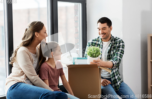 Image of happy family with child moving to new home