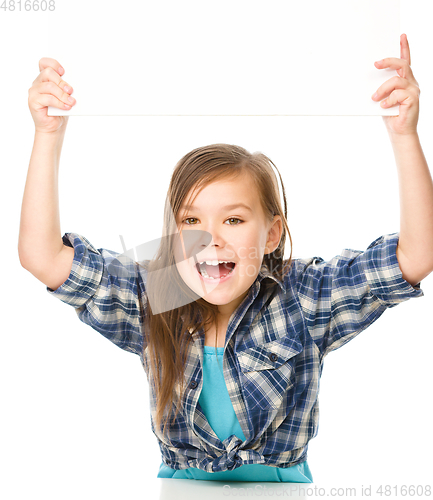 Image of Little girl is holding a blank banner