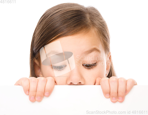 Image of Little girl is looking from out blank board