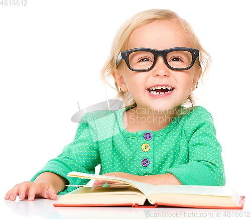 Image of Little girl is reading her book