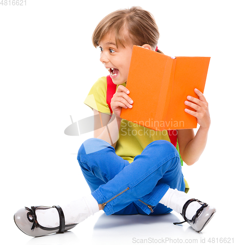 Image of Portrait of a cute little schoolgirl with backpack