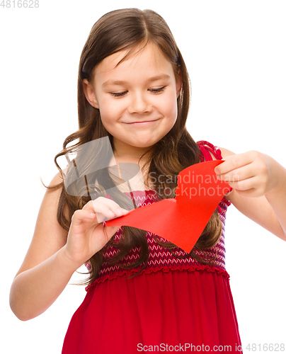 Image of Portrait of a sad little girl in red