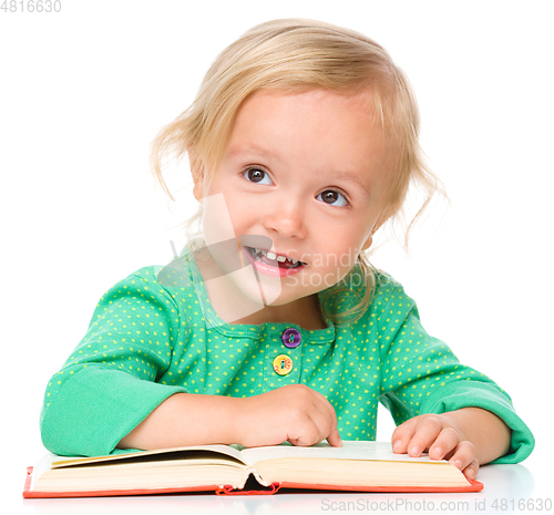 Image of Little girl is reading her book