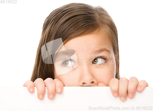 Image of Little girl is looking from out blank board