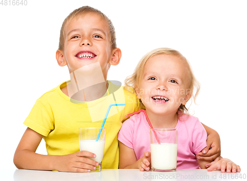 Image of Cute little girl and boy are drinking milk