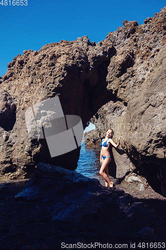 Image of beautiful girl resting in natural ocean swimming pool