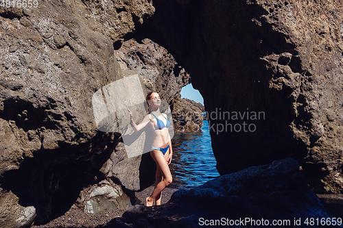 Image of beautiful girl resting in natural ocean swimming pool