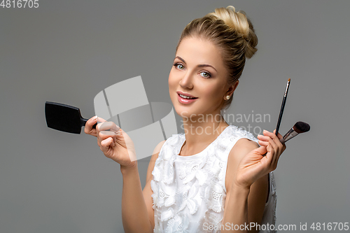 Image of beautiful girl applying makeup