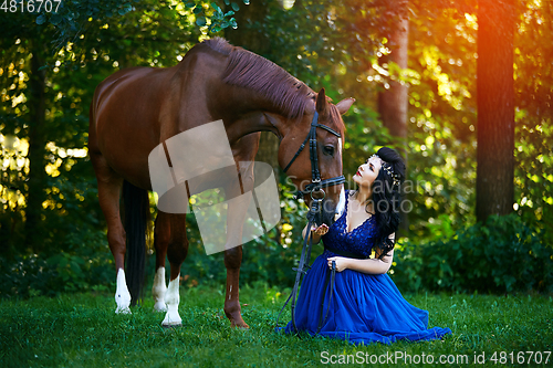 Image of beautiful girl in dress with horse